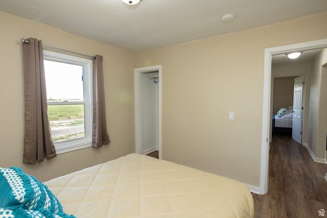 566 S Main St, Lyman, UT 84749 - bedroom featuring dark wood-type flooring and baseboards