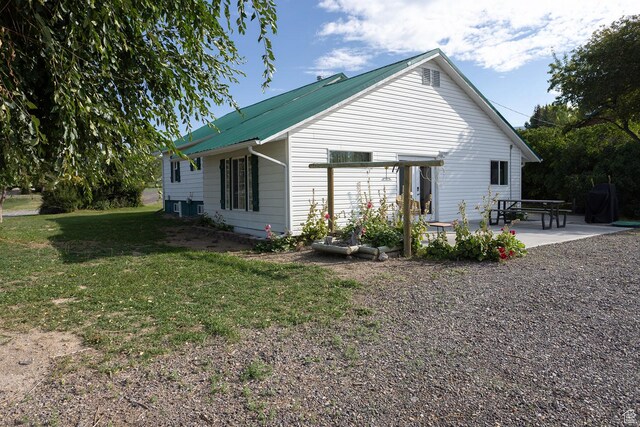 566 S Main St, Lyman, UT 84749 - rear view of property with a lawn and a patio
