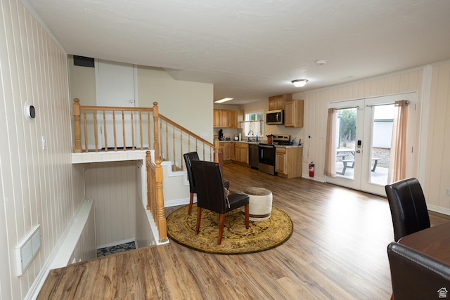 566 S Main St, Lyman, UT 84749 - living area featuring light wood-style floors, french doors, stairway, and baseboards