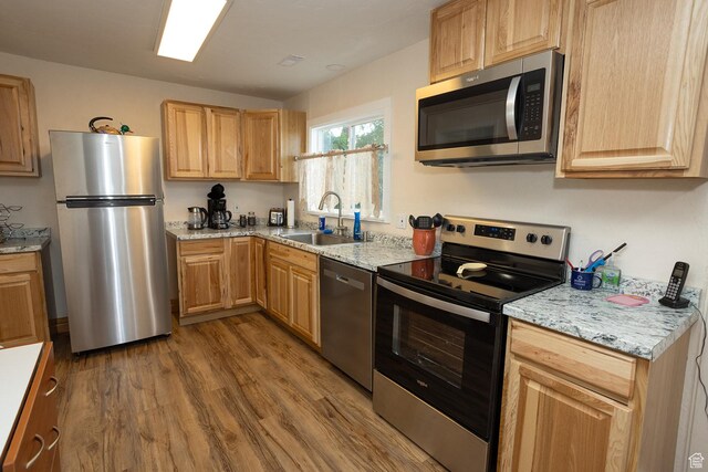 566 S Main St, Lyman, UT 84749 - kitchen with appliances with stainless steel finishes, a sink, wood finished floors, light brown cabinets, and light stone counters