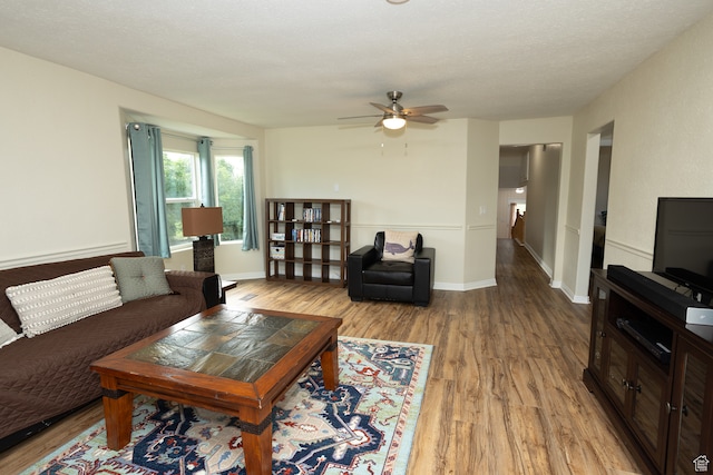 566 S Main St, Lyman, UT 84749 - living room featuring wood finished floors, ceiling fan, and baseboards