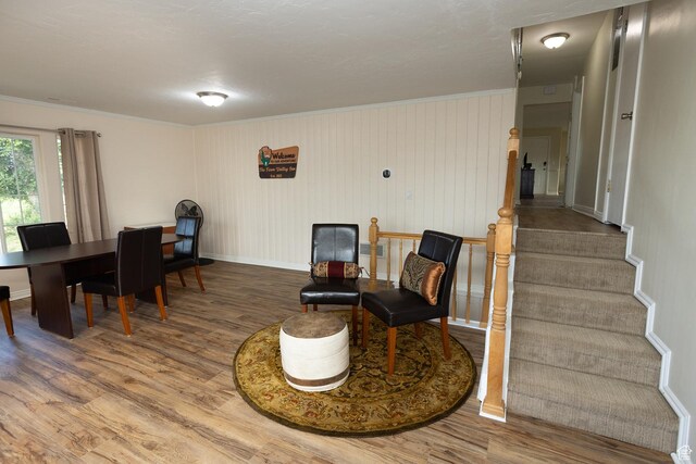566 S Main St, Lyman, UT 84749 - living area featuring wood finished floors, ornamental molding, baseboards, and stairway