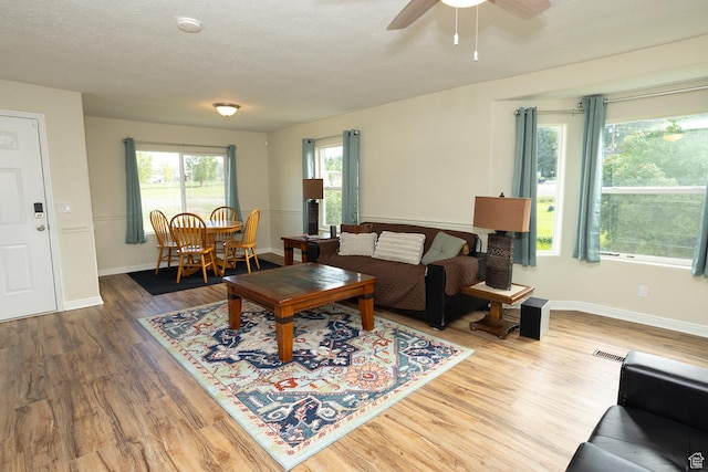 566 S Main St, Lyman, UT 84749 - living area featuring wood finished floors, ceiling fan, and baseboards