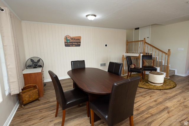566 S Main St, Lyman, UT 84749 - dining room with wood finished floors, stairs, baseboards, and crown molding