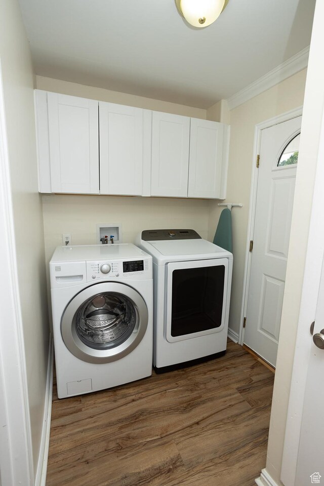 566 S Main St, Lyman, UT 84749 - laundry room featuring washing machine and dryer, cabinet space, dark wood-style floors, ornamental molding, and baseboards