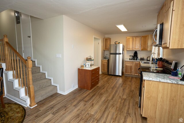 566 S Main St, Lyman, UT 84749 - kitchen with appliances with stainless steel finishes, dark wood-style floors, baseboards, a sink, and light stone countertops
