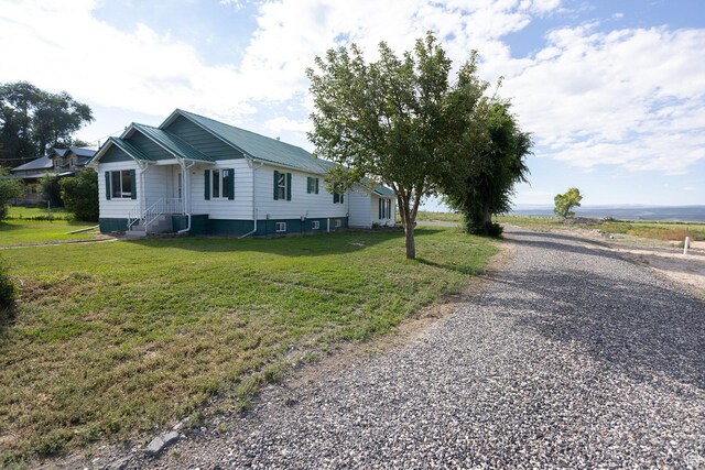566 S Main St, Lyman, UT 84749 - view of home's exterior featuring a yard and gravel driveway