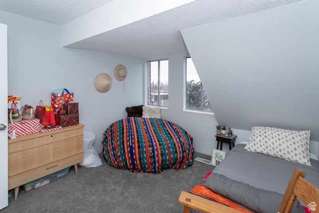 bedroom with carpet and a textured ceiling