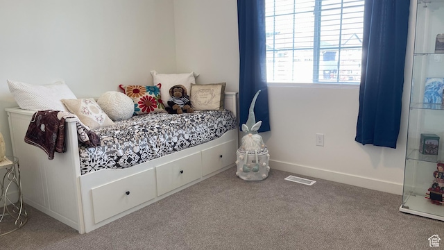 carpeted bedroom with baseboards and visible vents