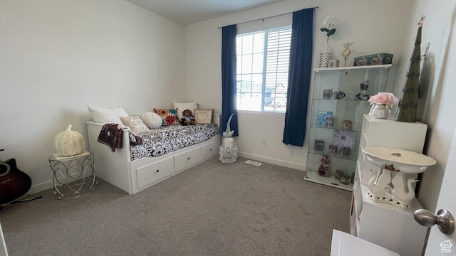 bedroom featuring baseboards, visible vents, and carpet