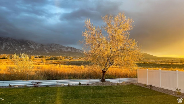 view of yard with a mountain view and fence