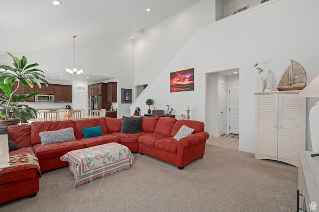living room featuring baseboards, recessed lighting, a chandelier, light colored carpet, and high vaulted ceiling