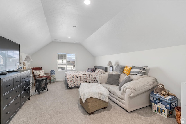bedroom with light carpet, vaulted ceiling, visible vents, and baseboards