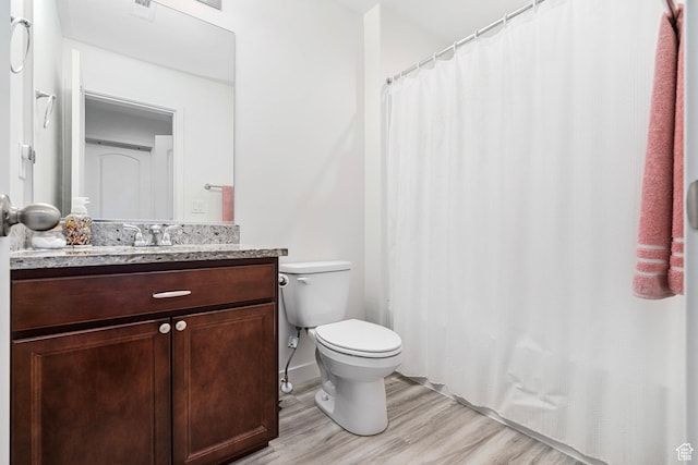 full bathroom featuring toilet, a shower with curtain, vanity, and wood finished floors
