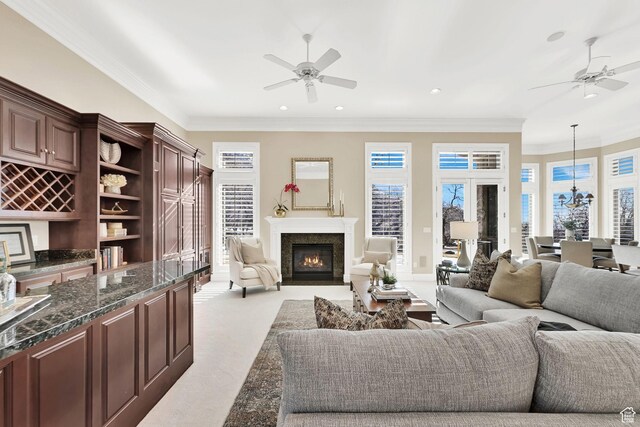 5210 Skyline Pkwy, Ogden, UT 84403 - living area featuring a fireplace with flush hearth, ornamental molding, and ceiling fan with notable chandelier