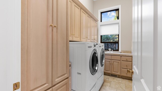 5210 Skyline Pkwy, Ogden, UT 84403 - clothes washing area with visible vents, stone finish floor, a sink, cabinet space, and washer and clothes dryer