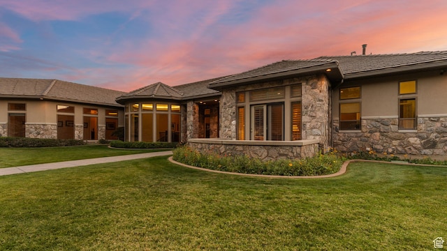 5210 Skyline Pkwy, Ogden, UT 84403 - prairie-style house featuring stone siding, a tile roof, a front yard, and stucco siding