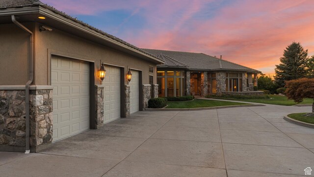 5210 Skyline Pkwy, Ogden, UT 84403 - view of front of home featuring stone siding, driveway, stucco siding, and an attached garage