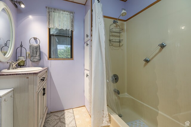 bathroom featuring crown molding, vanity, tile patterned floors, and shower / bath combo