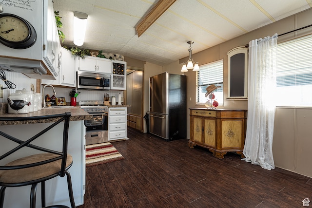 kitchen featuring white cabinets, stainless steel appliances, dark hardwood / wood-style floors, and sink