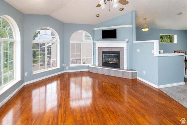 232 Bugle Way, Providence, UT 84332 - unfurnished living room with a ceiling fan, a healthy amount of sunlight, vaulted ceiling, and wood finished floors