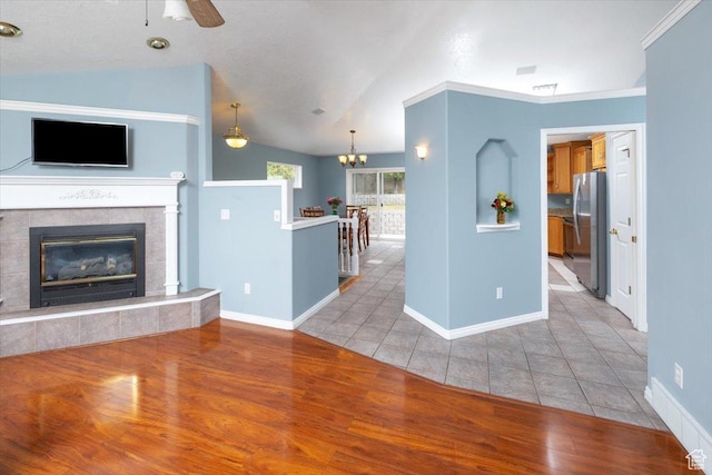 232 Bugle Way, Providence, UT 84332 - unfurnished living room with ceiling fan with notable chandelier, light wood-style floors, baseboards, and lofted ceiling