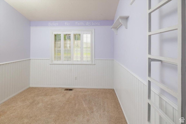 232 Bugle Way, Providence, UT 84332 - spare room featuring a wainscoted wall, visible vents, and carpet floors