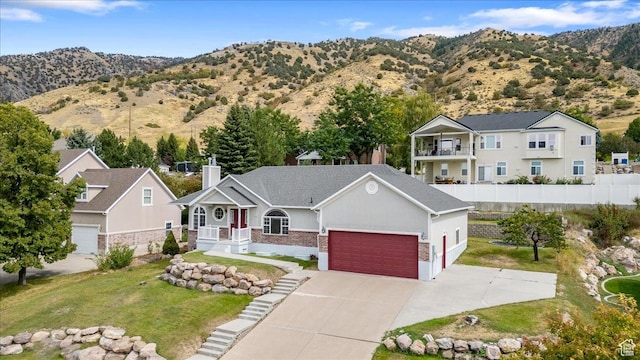 232 Bugle Way, Providence, UT 84332 - view of front facade with fence, driveway, a front yard, a garage, and a chimney