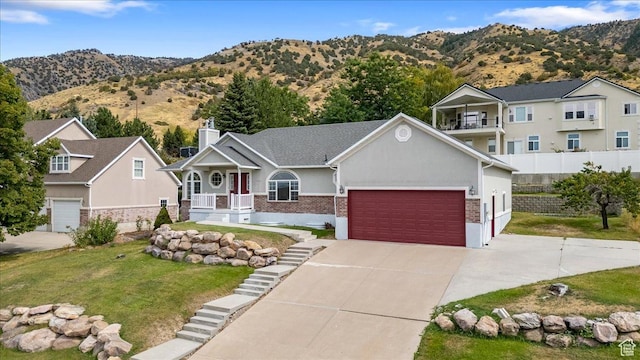 232 Bugle Way, Providence, UT 84332 - view of front of home featuring a garage, concrete driveway, a front lawn, stucco siding, and covered porch