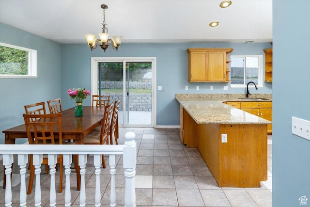 232 Bugle Way, Providence, UT 84332 - kitchen featuring a peninsula, light stone countertops, a sink, decorative light fixtures, and an inviting chandelier