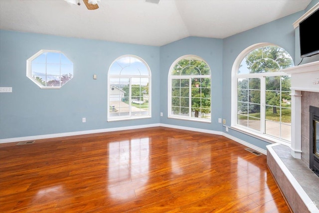 232 Bugle Way, Providence, UT 84332 - unfurnished living room with baseboards, lofted ceiling, wood finished floors, and a tile fireplace