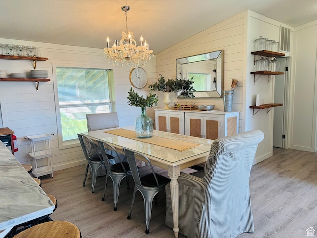 594 S Aspen Dr Unit 48, Garden City, UT 84028 - dining area featuring lofted ceiling, a chandelier, light wood-type flooring, and wooden walls