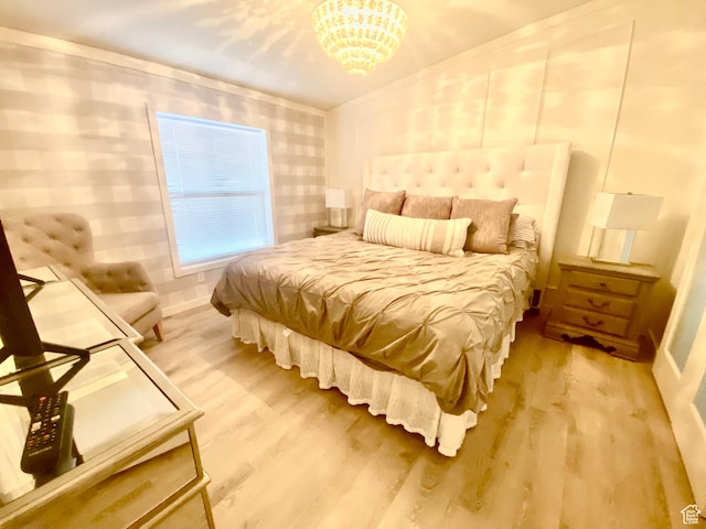 594 S Aspen Dr Unit 48, Garden City, UT 84028 - bedroom featuring a chandelier, baseboards, and light wood-style flooring