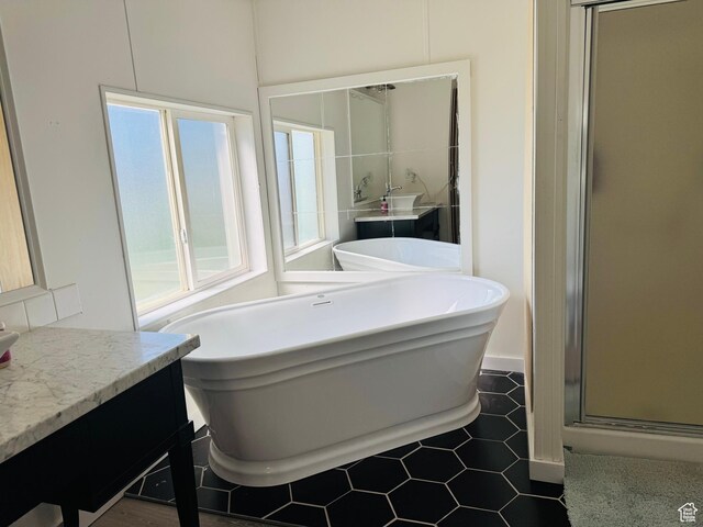 594 S Aspen Dr Unit 48, Garden City, UT 84028 - full bath with vanity, a freestanding tub, a shower stall, and tile patterned floors