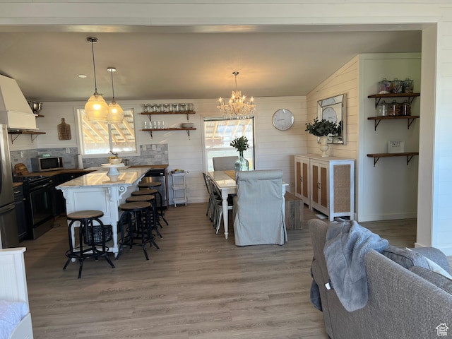 594 S Aspen Dr Unit 48, Garden City, UT 84028 - dining area with a chandelier, lofted ceiling, and wood finished floors
