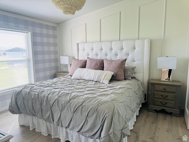 594 S Aspen Dr Unit 48, Garden City, UT 84028 - bedroom featuring wood finished floors and multiple windows