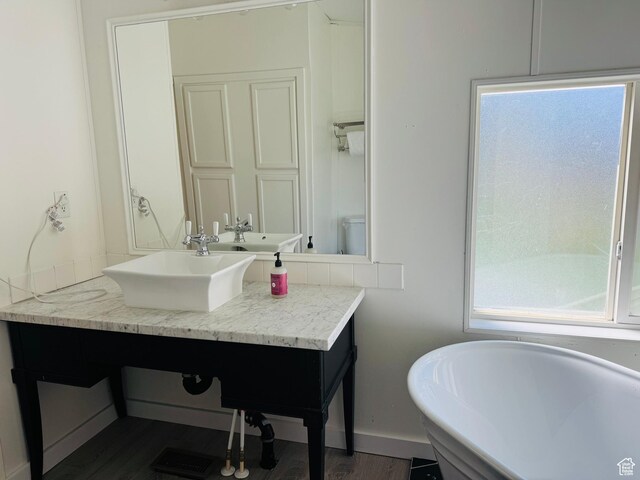 594 S Aspen Dr Unit 48, Garden City, UT 84028 - bathroom with a freestanding bath, vanity, wood finished floors, and baseboards