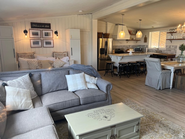 594 S Aspen Dr Unit 48, Garden City, UT 84028 - living room with a chandelier, light wood-style flooring, and lofted ceiling with beams