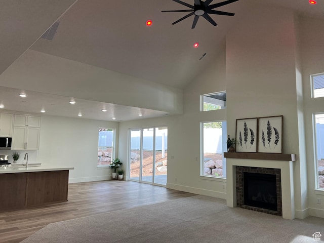 1136 N 1875 E Unit 1, Layton, UT 84040 - living room with baseboards, a high ceiling, ceiling fan, recessed lighting, and a fireplace