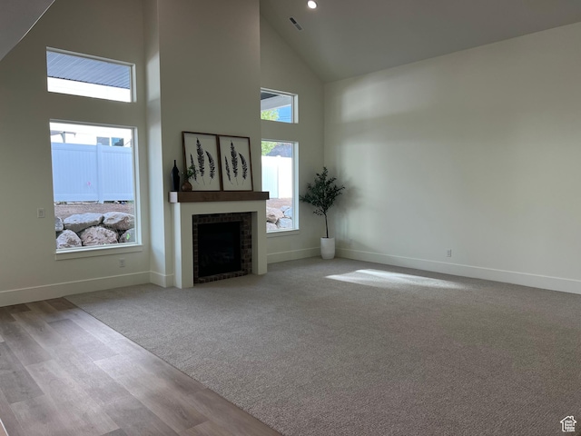1136 N 1875 E Unit 1, Layton, UT 84040 - unfurnished living room featuring high vaulted ceiling, a fireplace, baseboards, and wood finished floors