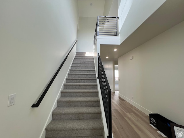 1136 N 1875 E Unit 1, Layton, UT 84040 - staircase featuring wood finished floors, baseboards, recessed lighting, and a towering ceiling