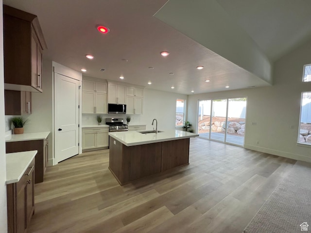 1136 N 1875 E Unit 1, Layton, UT 84040 - kitchen with appliances with stainless steel finishes, a sink, light wood-style flooring, recessed lighting, and light countertops