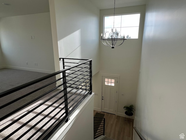 1136 N 1875 E Unit 1, Layton, UT 84040 - staircase with a chandelier, baseboards, wood finished floors, and a towering ceiling