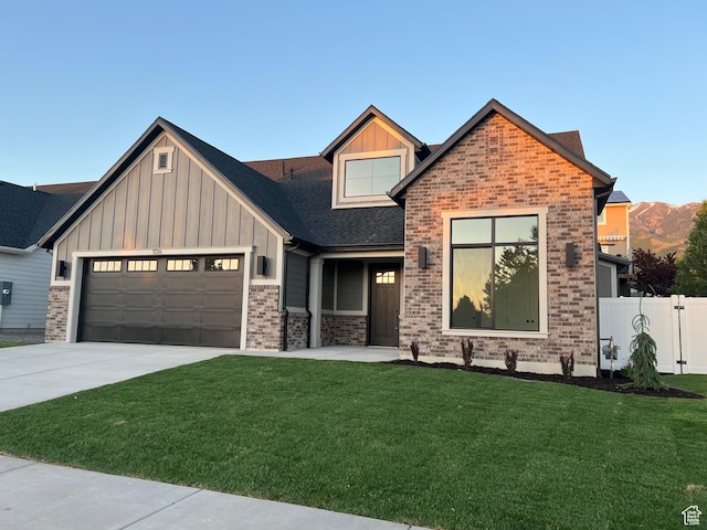 1136 N 1875 E Unit 1, Layton, UT 84040 - view of front of house with board and batten siding, an attached garage, concrete driveway, and brick siding