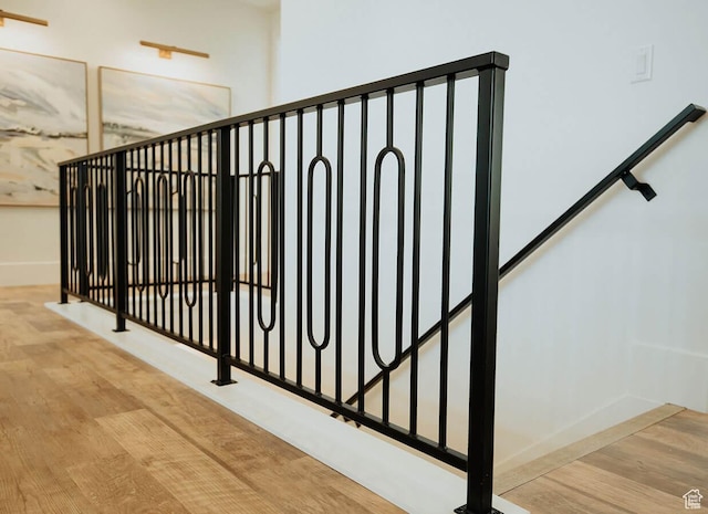 stairs featuring baseboards and wood finished floors