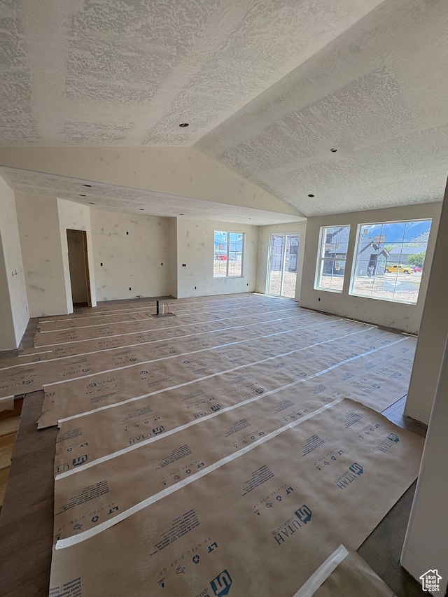 314 N 1040 E Unit 24, Salem, UT 84653 - unfurnished living room featuring vaulted ceiling and a textured ceiling