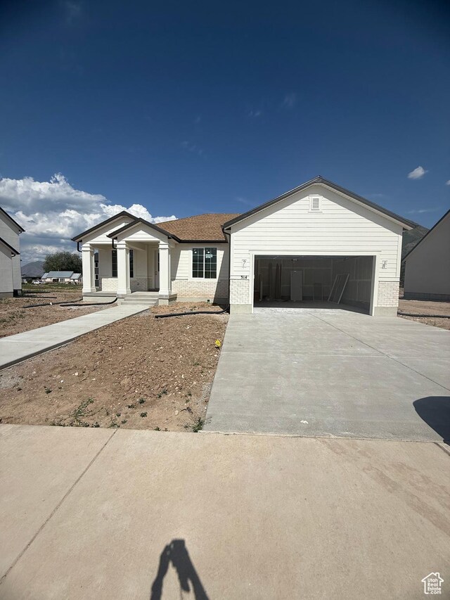 314 N 1040 E Unit 24, Salem, UT 84653 - ranch-style house featuring concrete driveway, an attached garage, brick siding, and covered porch