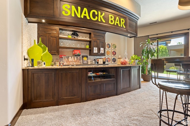2596 E Flint St, St George, UT 84790 - bar featuring visible vents, a bar, carpet, and decorative backsplash
