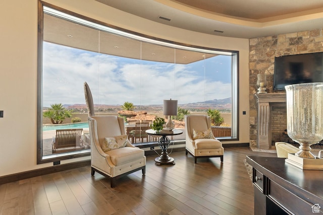 2596 E Flint St, St George, UT 84790 - sitting room featuring a fireplace, visible vents, dark wood finished floors, and baseboards