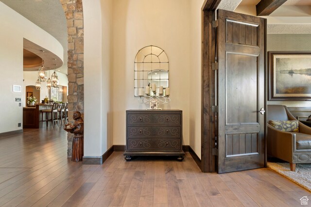 2596 E Flint St, St George, UT 84790 - hallway featuring a chandelier, baseboards, and wood-type flooring
